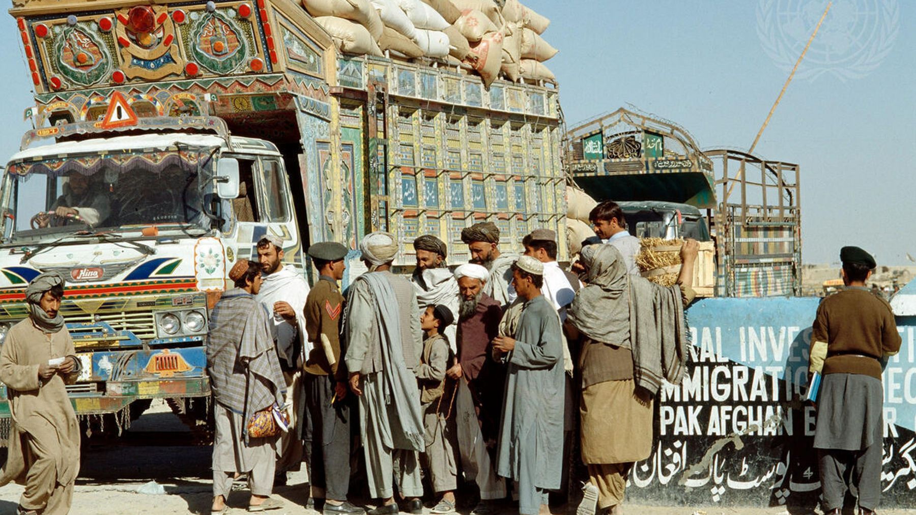 Men standing in front of a truck.